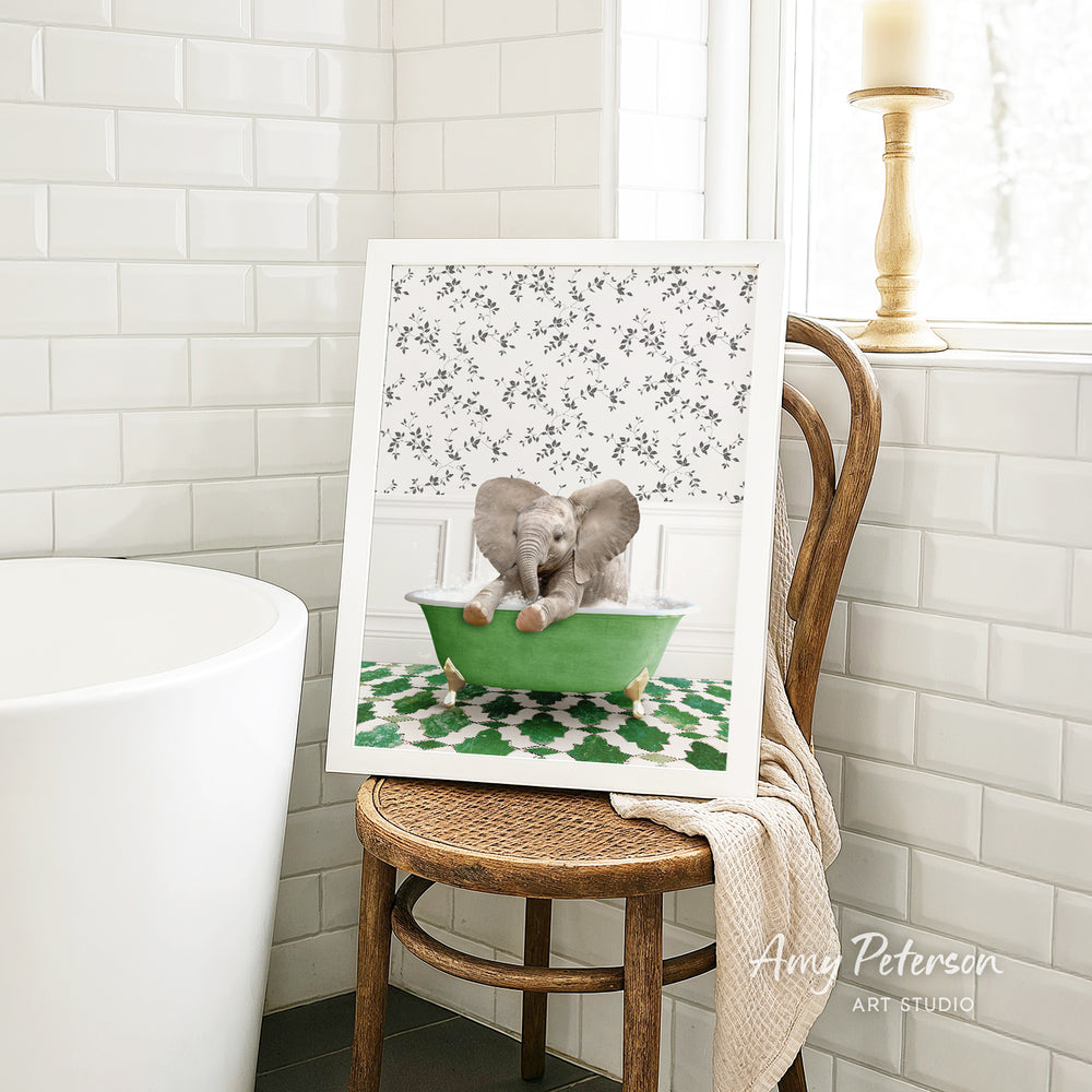A framed image of two elephants sitting in a green bathtub, with a floral pattern on the wall behind them.