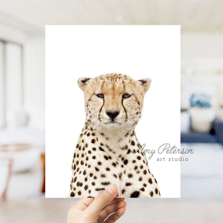 a hand holding a card with a picture of a cheetah