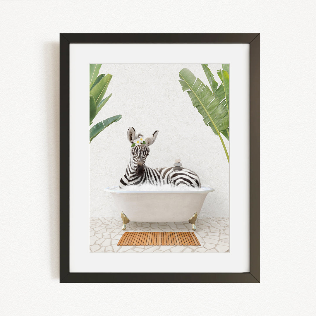 A zebra is sitting in a white bathtub, surrounded by green plants, in the image.