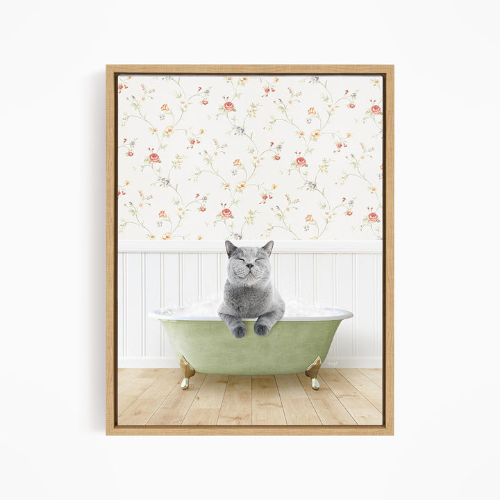 A gray cat sitting in a green bathtub, with a floral wallpaper in the background.