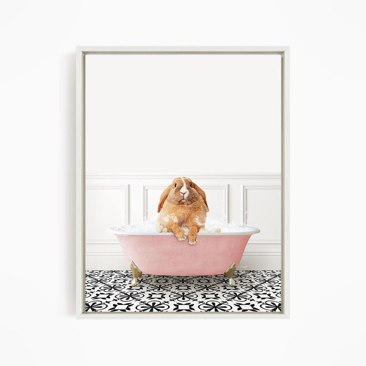 A brown rabbit sitting in a pink bathtub filled with bubbles, surrounded by a black and white patterned floor.