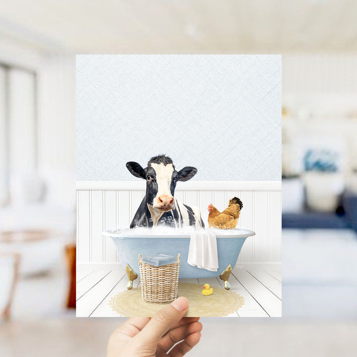 A cow and a chicken are sitting in a bathtub filled with water, surrounded by a basket and a rubber duck.