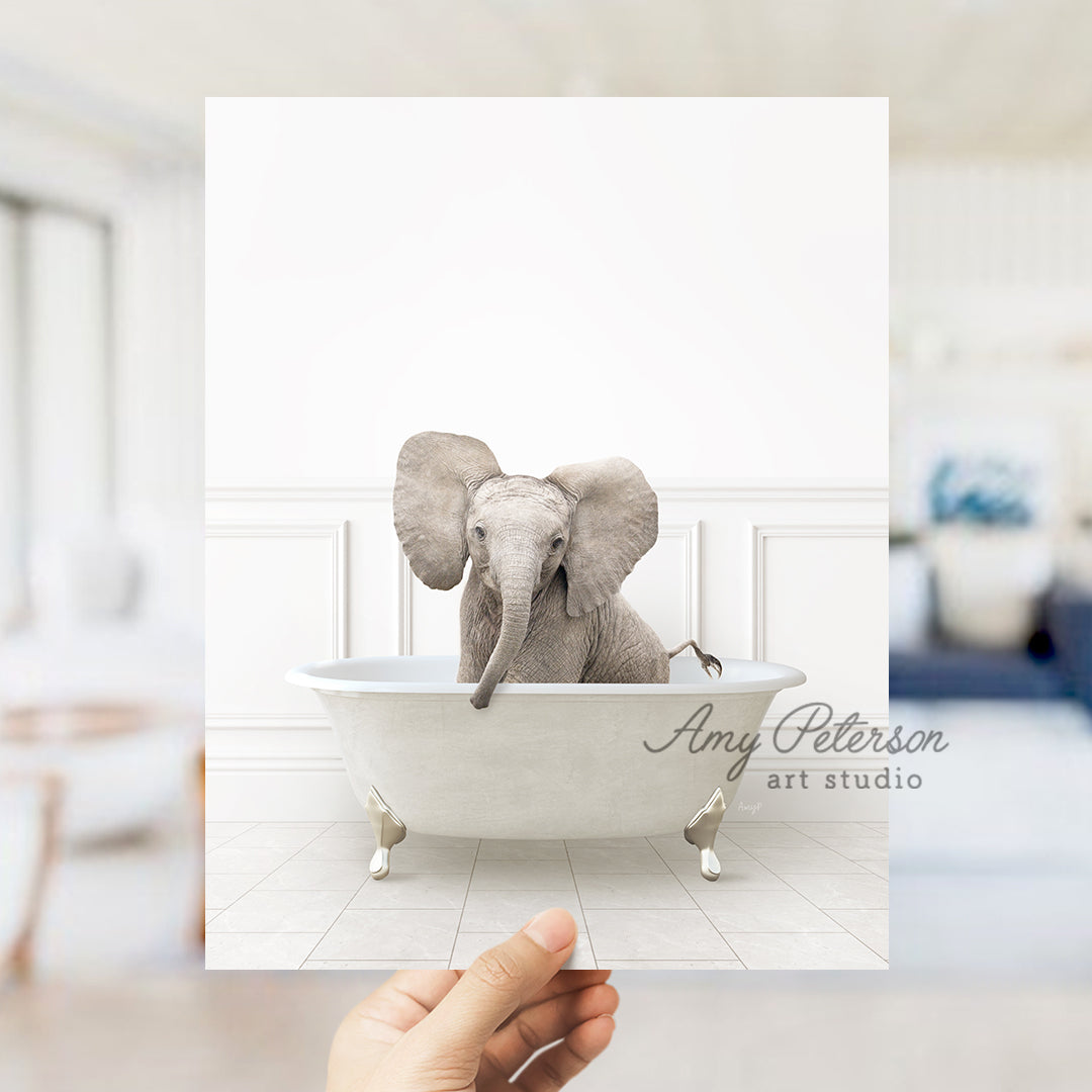 a hand holding a card with an elephant in a bathtub