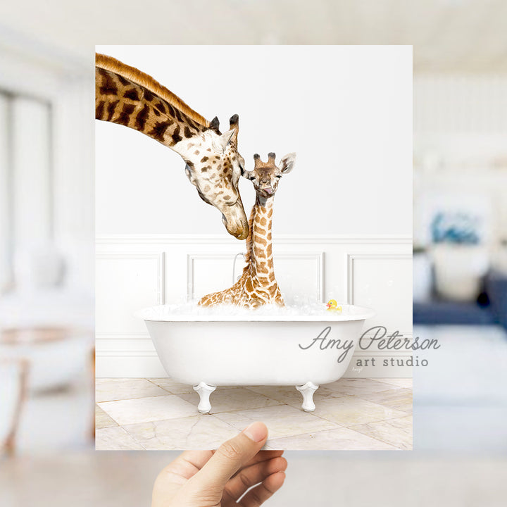 a hand holding up a card with two giraffes in a bathtub