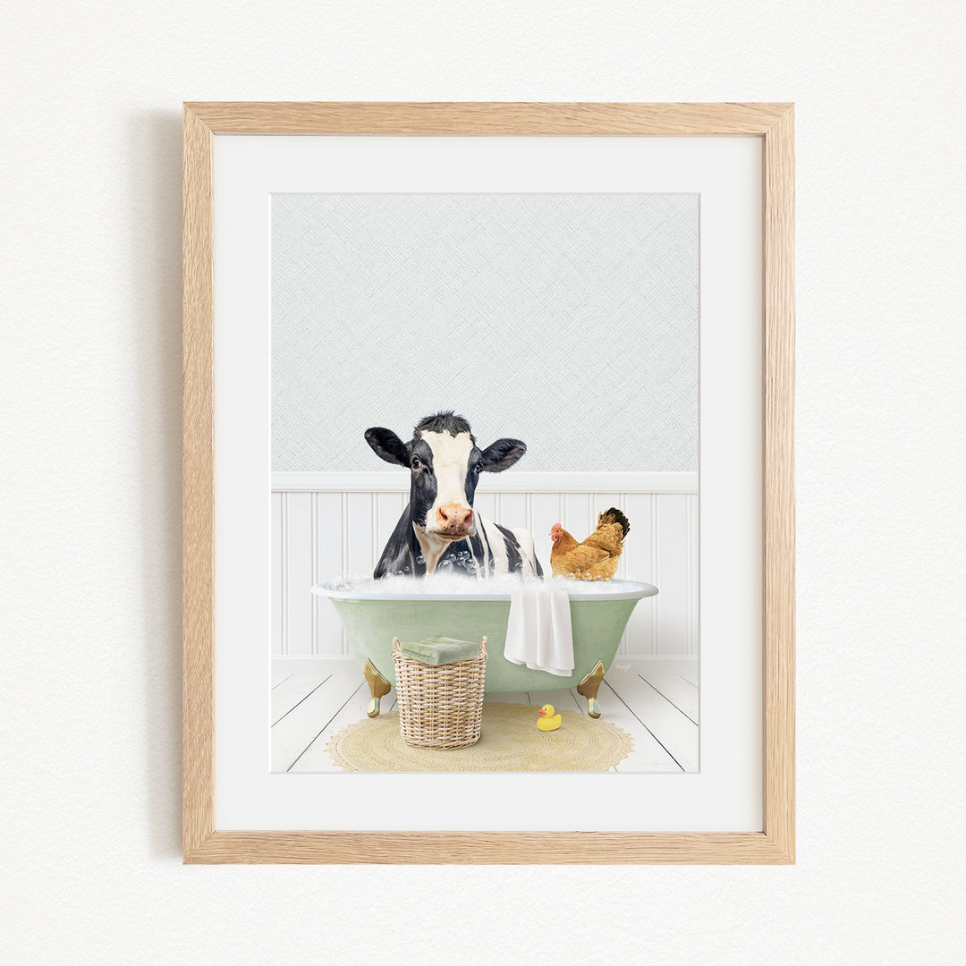A framed image depicting a cow sitting in a bathtub, surrounded by a chicken and a duck, creating a whimsical and playful scene.