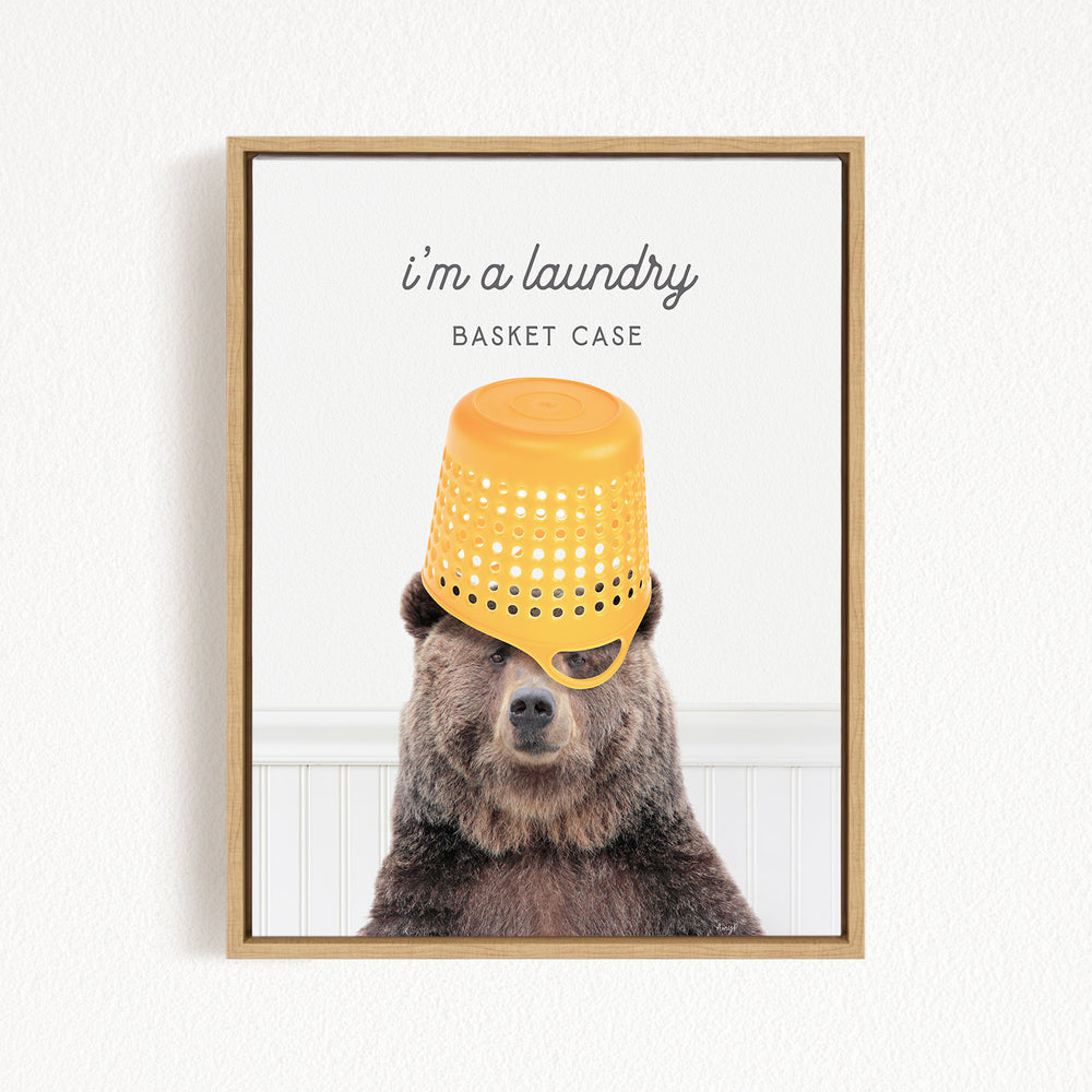 A brown bear wearing a yellow plastic basket on its head, with the text "I'm a laundry basket case" above the bear.