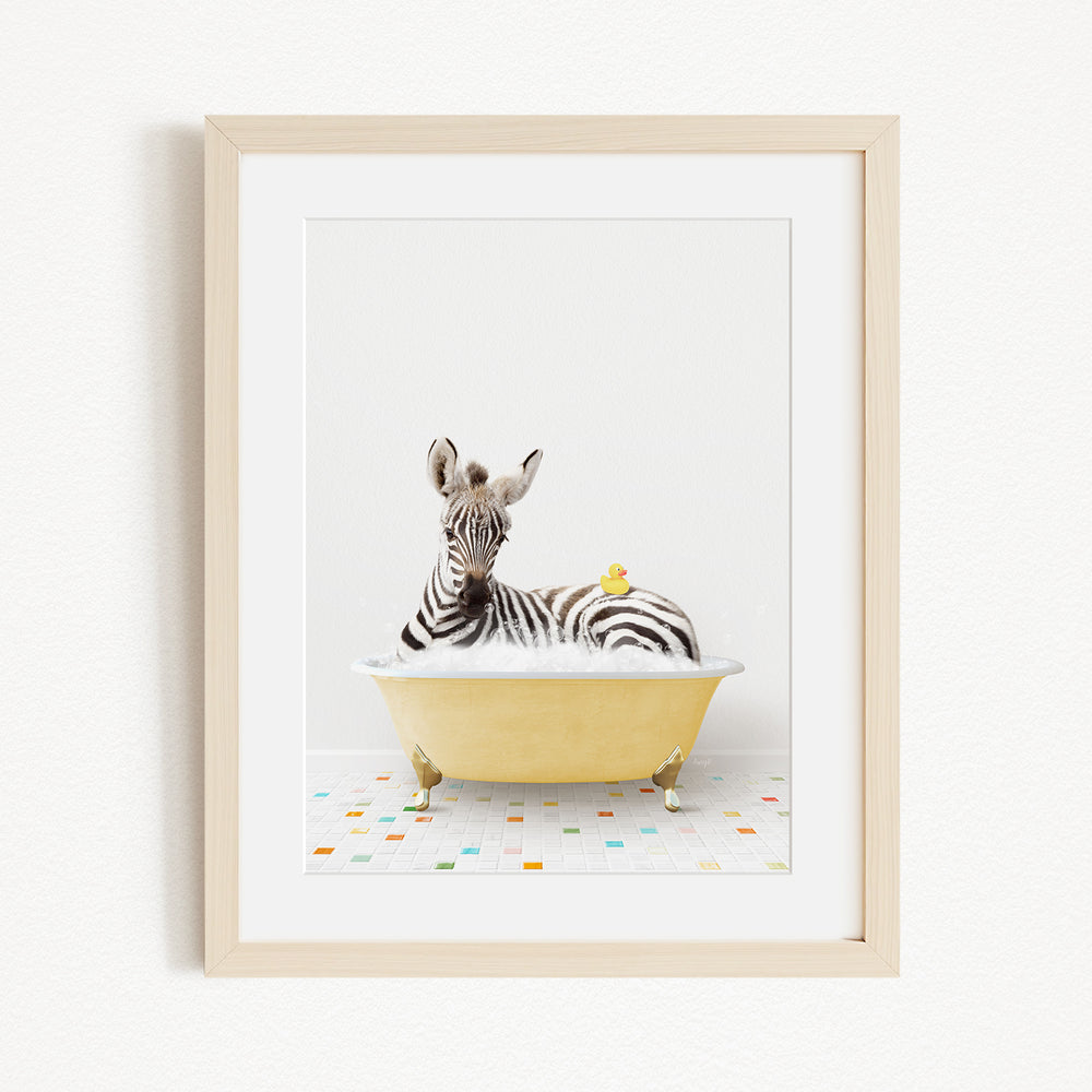 A zebra is sitting in a yellow bathtub, with a yellow rubber duck resting on its back.