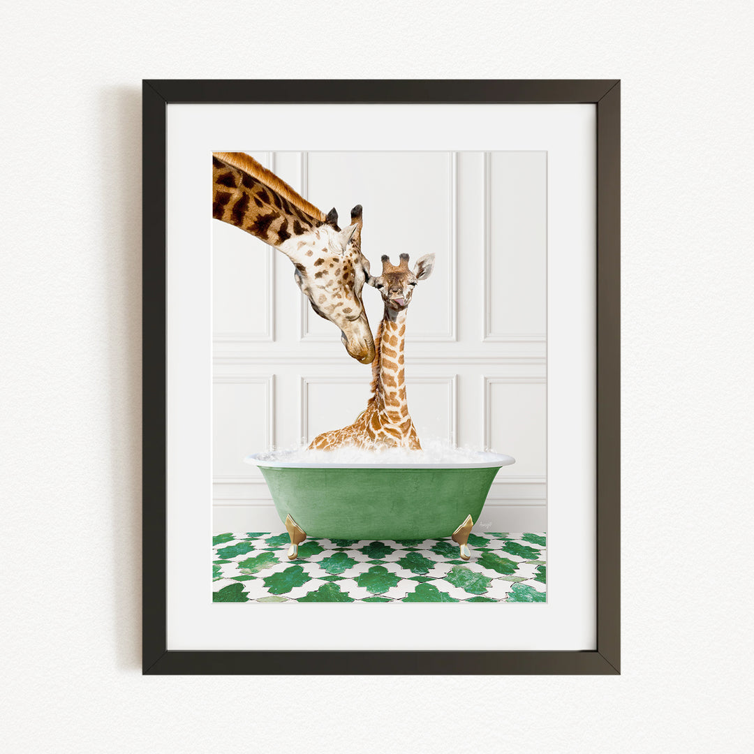 A mother giraffe and her baby giraffe are sitting together in a green bathtub, with the mother gently licking her baby.
