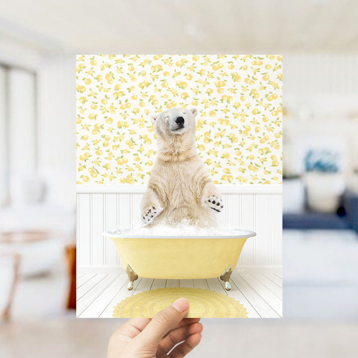 A polar bear sitting in a yellow bathtub filled with bubbles, surrounded by a yellow floral pattern on the walls.