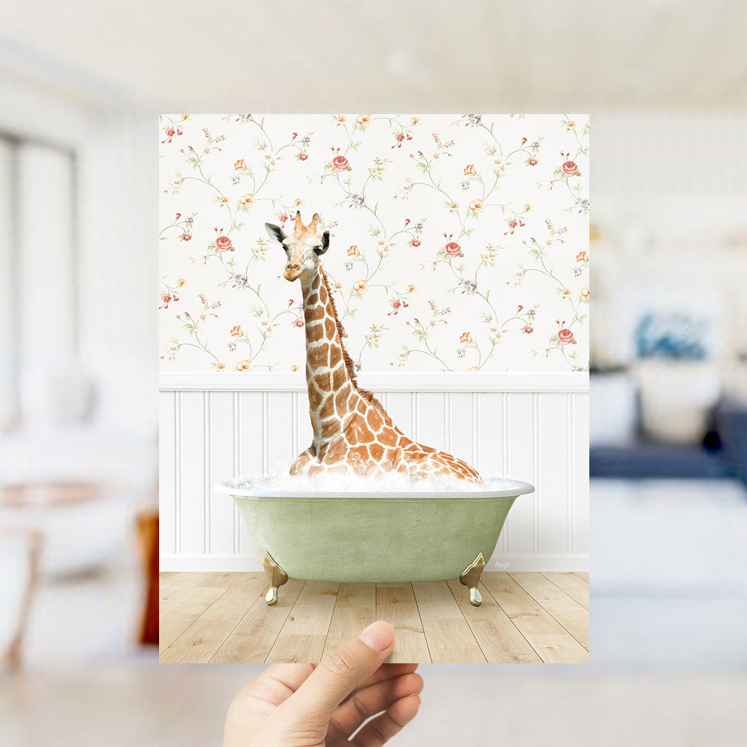 A giraffe sitting in a green bathtub filled with bubbles, surrounded by a floral wallpaper.
