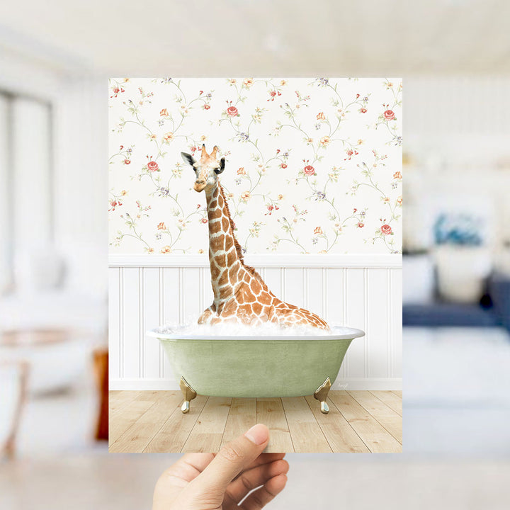 A giraffe sitting in a green bathtub filled with bubbles, surrounded by a floral wallpaper.