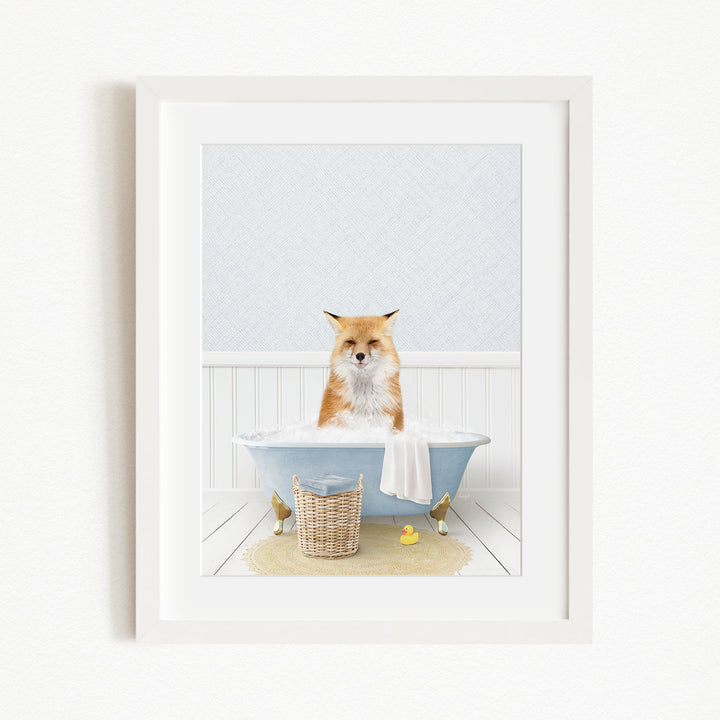 A red fox is sitting in a blue bathtub filled with bubbles, surrounded by rubber ducks and a basket.