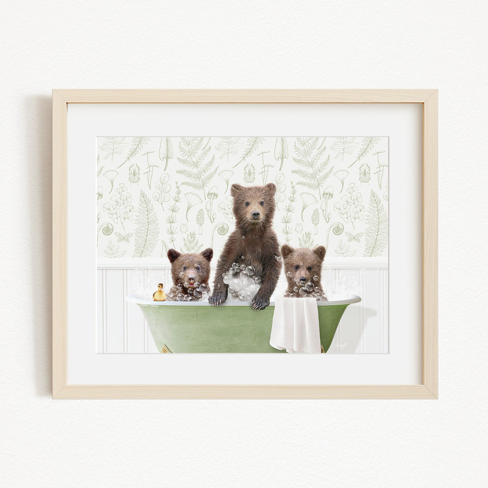 A framed image depicting three bears sitting in a green bathtub, with one bear standing and the other two sitting.