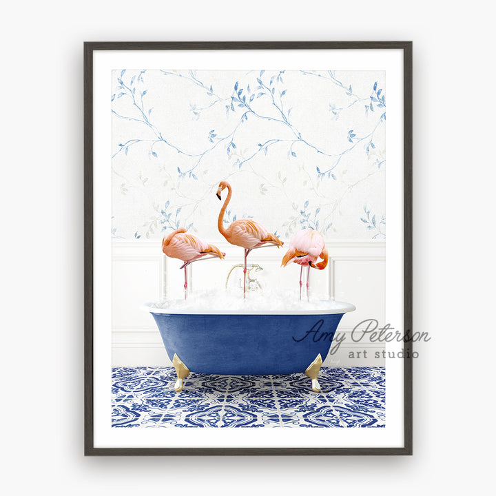 three pink flamingos in a blue bath tub