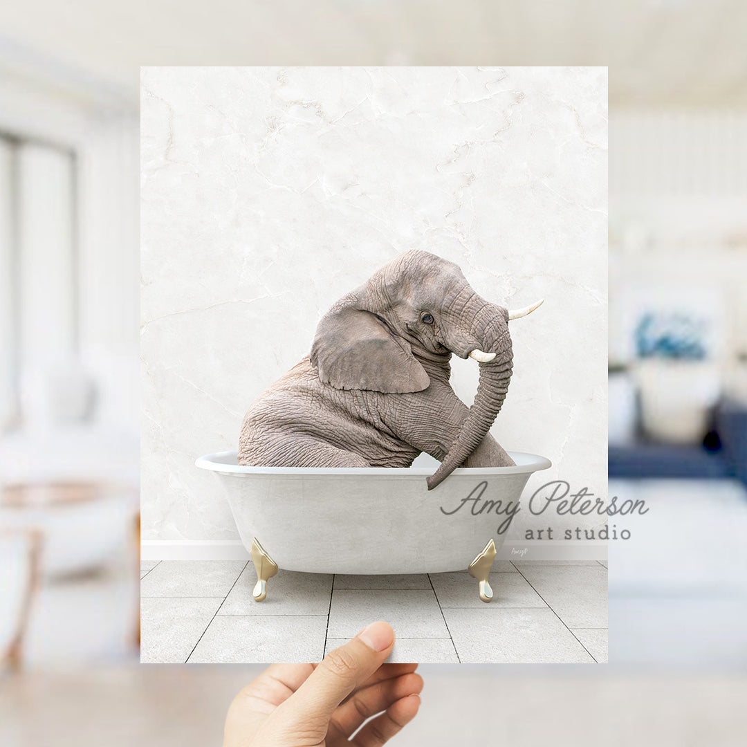 a person holding up a picture of an elephant in a bathtub