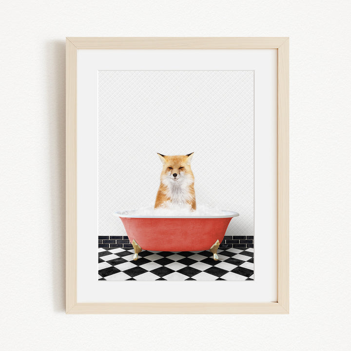 A red bathtub filled with water, with a cat sitting inside and looking at the camera.