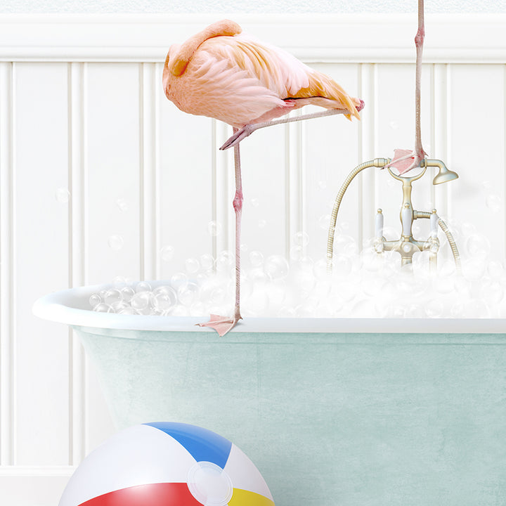 a flamingo standing in a bathtub next to a beach ball