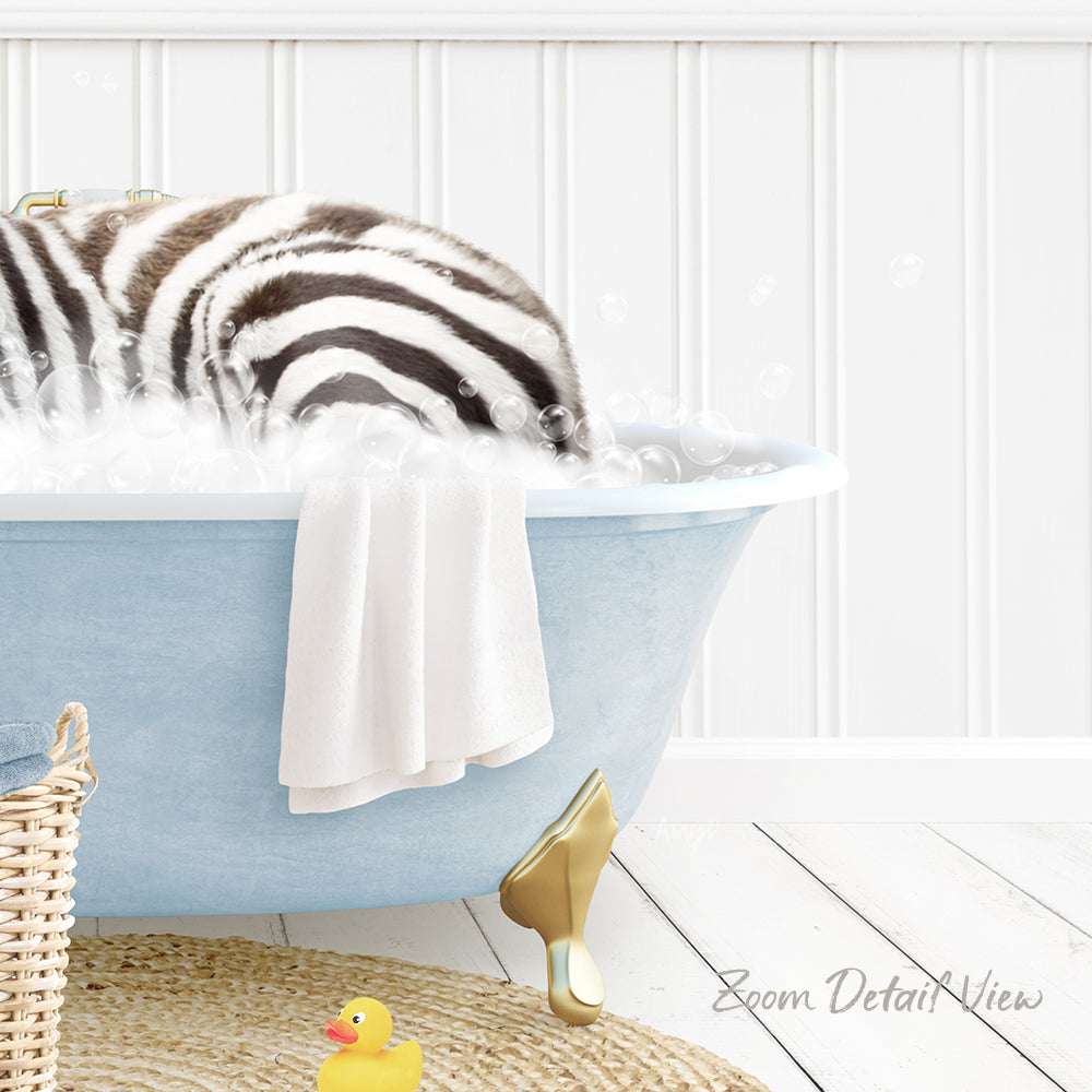 A zebra lying in a blue bathtub filled with bubbles, surrounded by a yellow rubber duck and a towel.