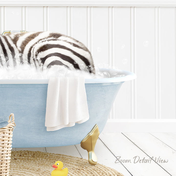 A zebra lying in a blue bathtub filled with bubbles, surrounded by a yellow rubber duck and a towel.