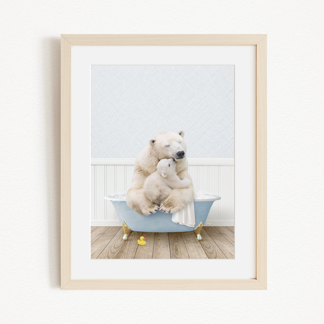 A framed image depicting two polar bears sitting in a bathtub, with one bear appearing to be hugging the other.
