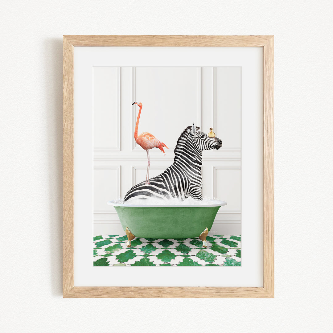 A framed image depicting a zebra sitting in a green bathtub, with a flamingo standing on its back and a bird perched on its head.