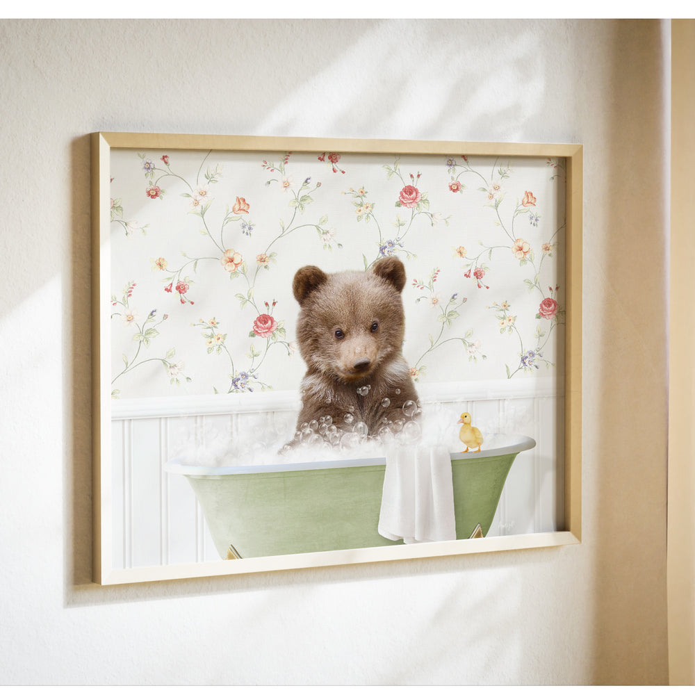 A brown bear sitting in a green bathtub filled with bubbles, with a yellow duck nearby, against a floral wallpaper background.