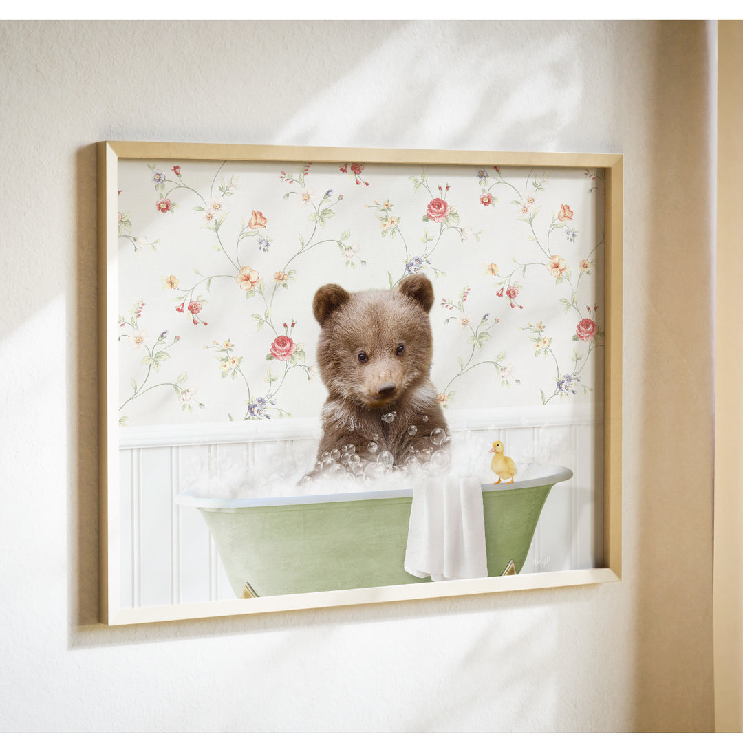 A brown bear sitting in a green bathtub filled with bubbles, with a yellow duck nearby, against a floral wallpaper background.