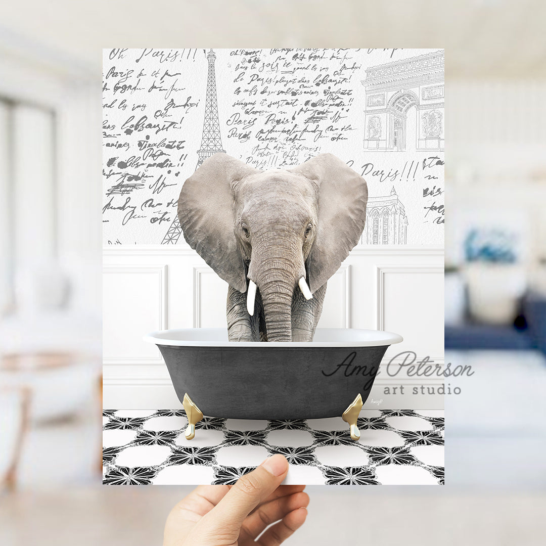 a person holding up a card with an elephant in a bathtub