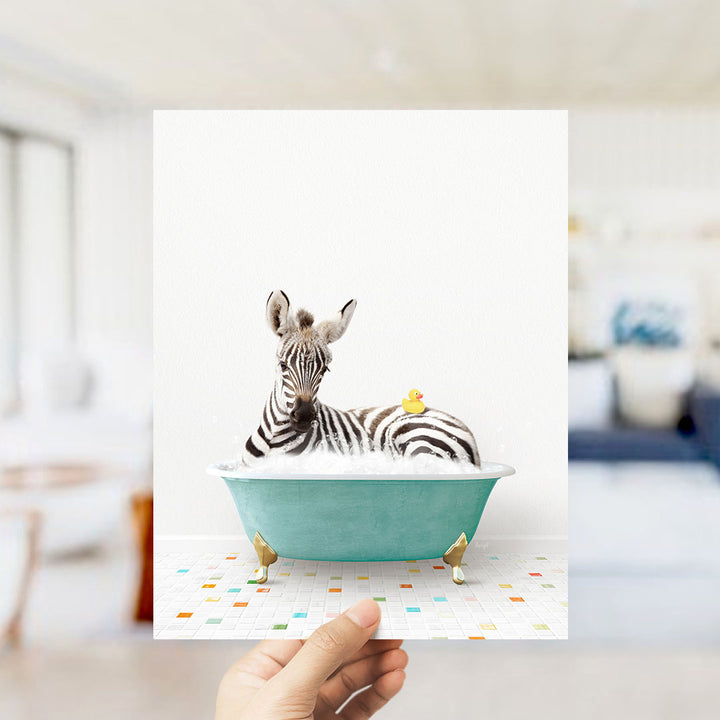 A zebra is sitting in a green bathtub, with a yellow rubber duck perched on its back.