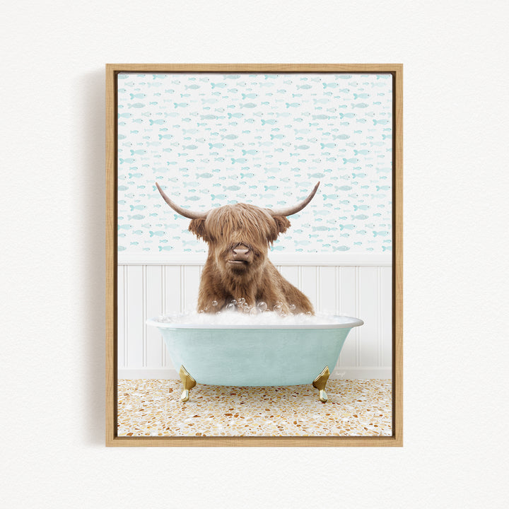 A brown cow with long horns is sitting in a light blue bathtub filled with bubbles, surrounded by a pattern of small fish.