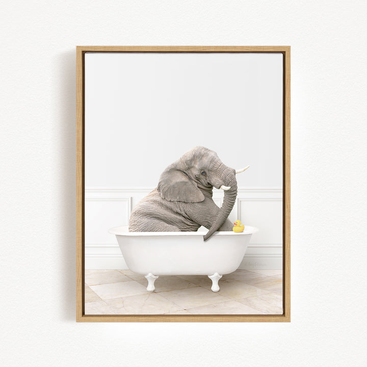 A gray elephant is sitting in a white bathtub, holding a yellow rubber duck.