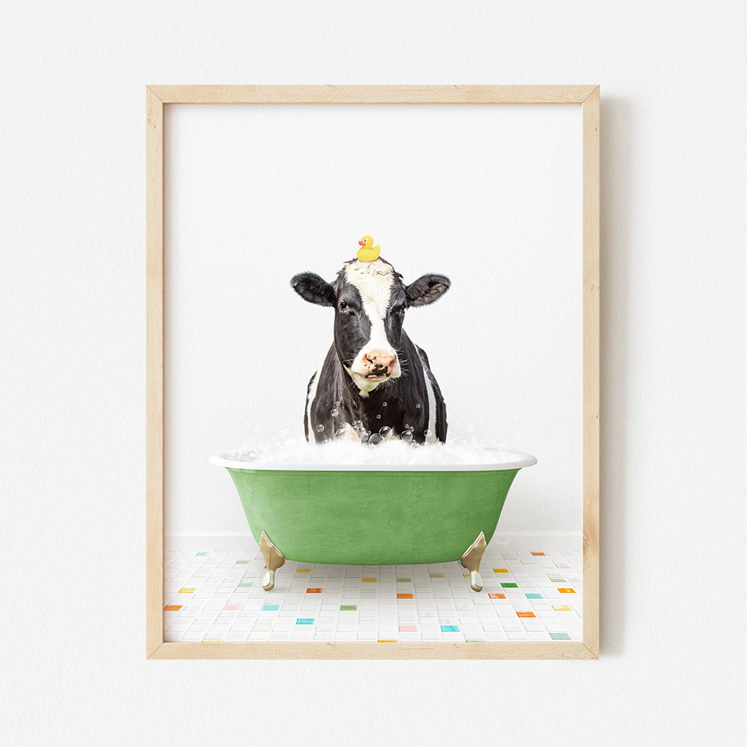 a black and white cow in a green bathtub