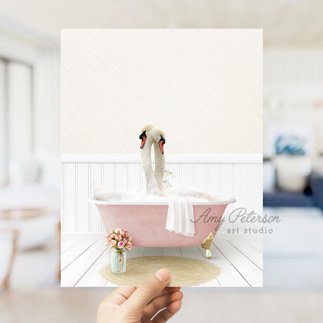 a person holding a card with a picture of two swans in a bathtub