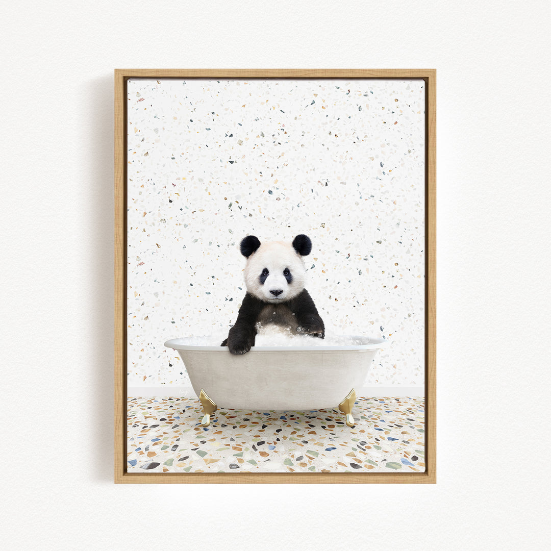 A panda bear sitting in a white bathtub against a speckled white background.