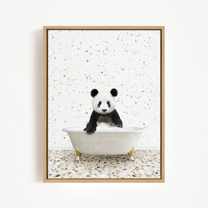 A panda bear sitting in a white bathtub against a speckled white background.