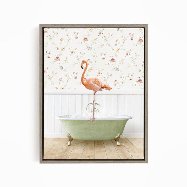 A pink flamingo stands on the edge of a green bathtub, with a floral wallpaper in the background.