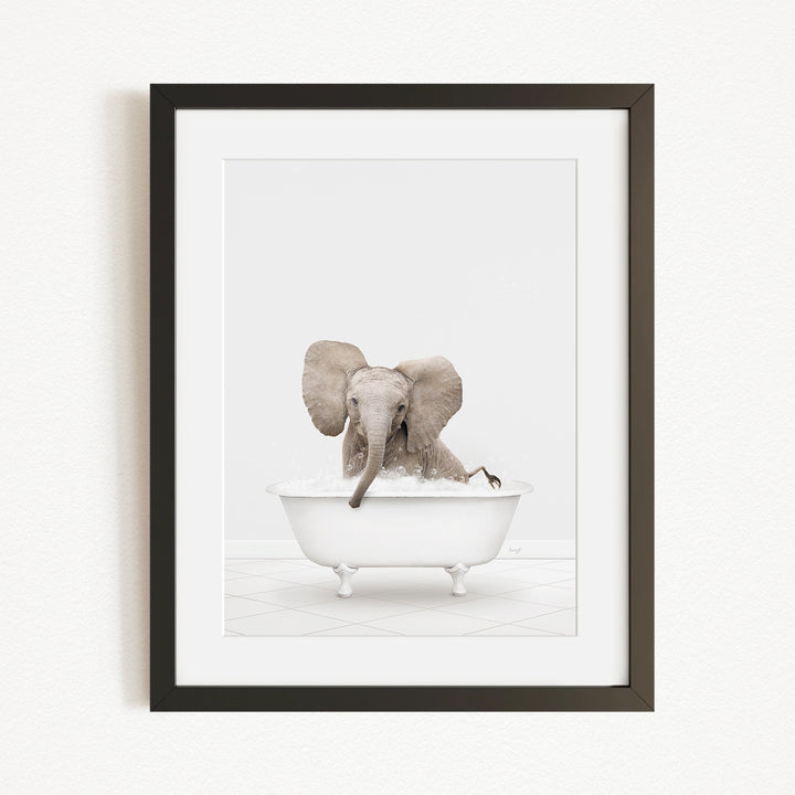 A baby elephant sitting in a bathtub filled with water, surrounded by a white background.