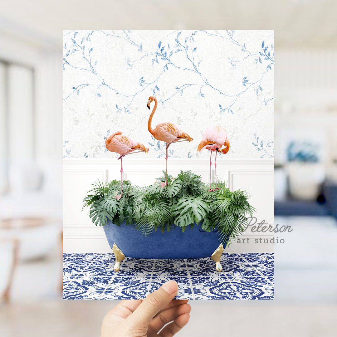 a hand holding a card with three flamingos in a planter