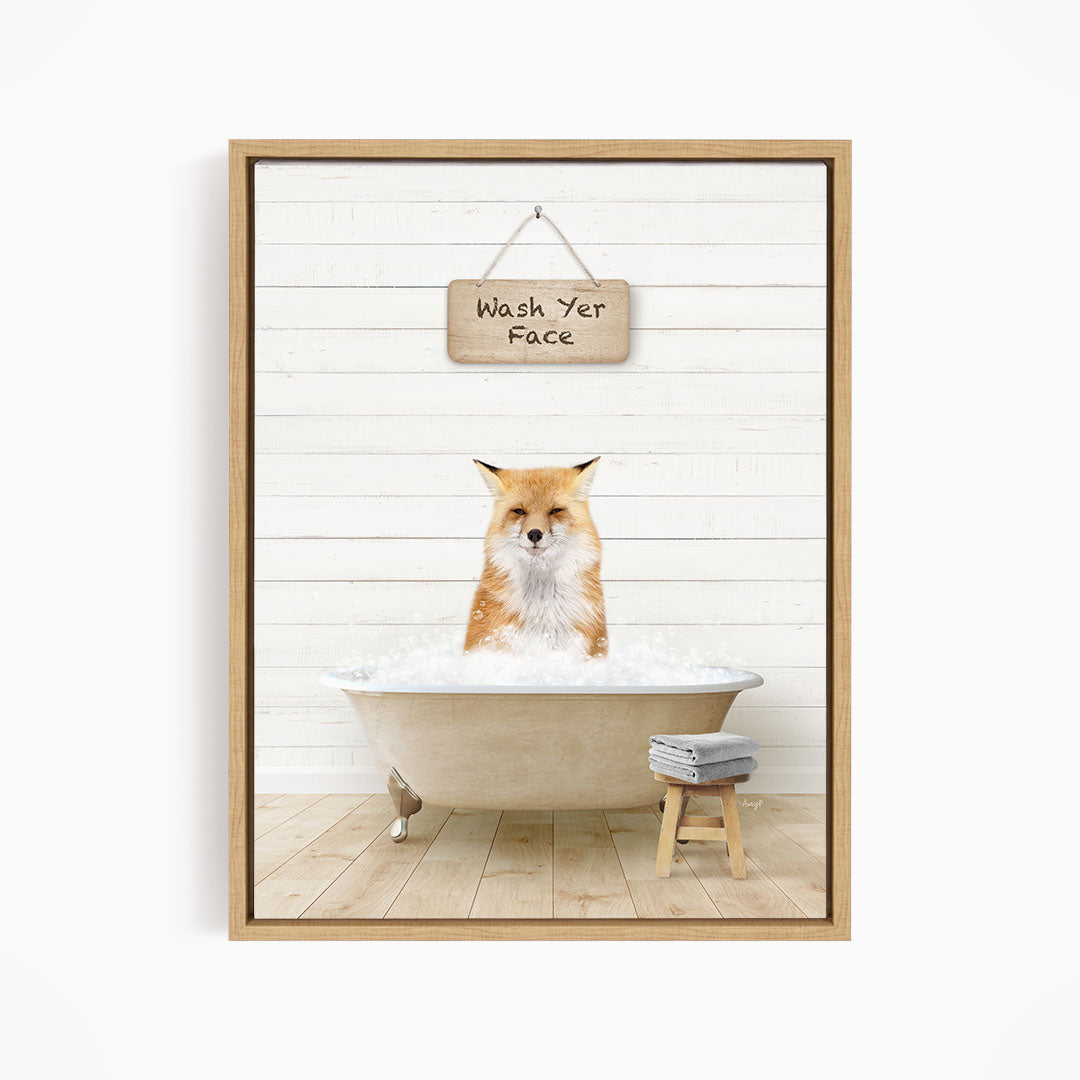 A framed image depicting a fox sitting in a bathtub filled with water, with a sign above that reads "Wash Yer Face".