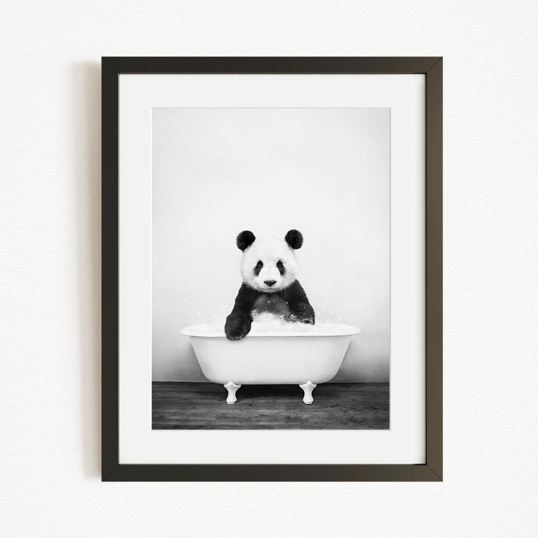 A panda bear sitting in a bathtub filled with bubbles, creating a whimsical and playful scene.