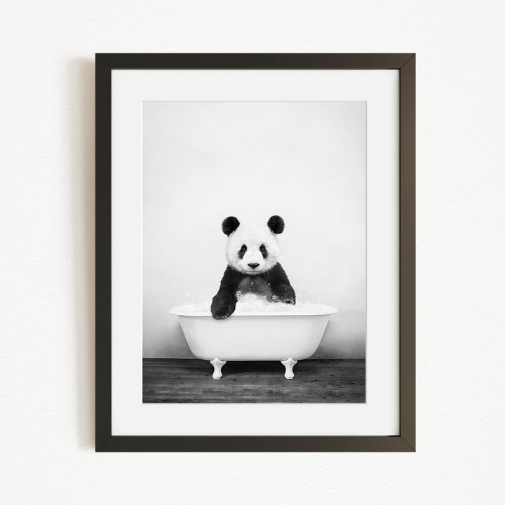 A panda bear sitting in a bathtub filled with bubbles, creating a whimsical and playful scene.