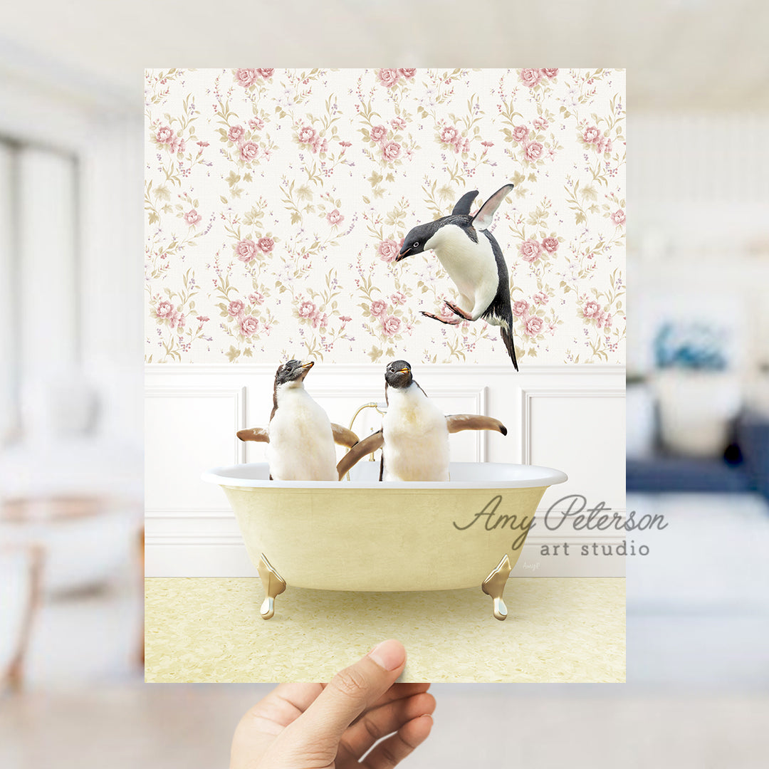 a hand holding a card with two penguins in a bathtub