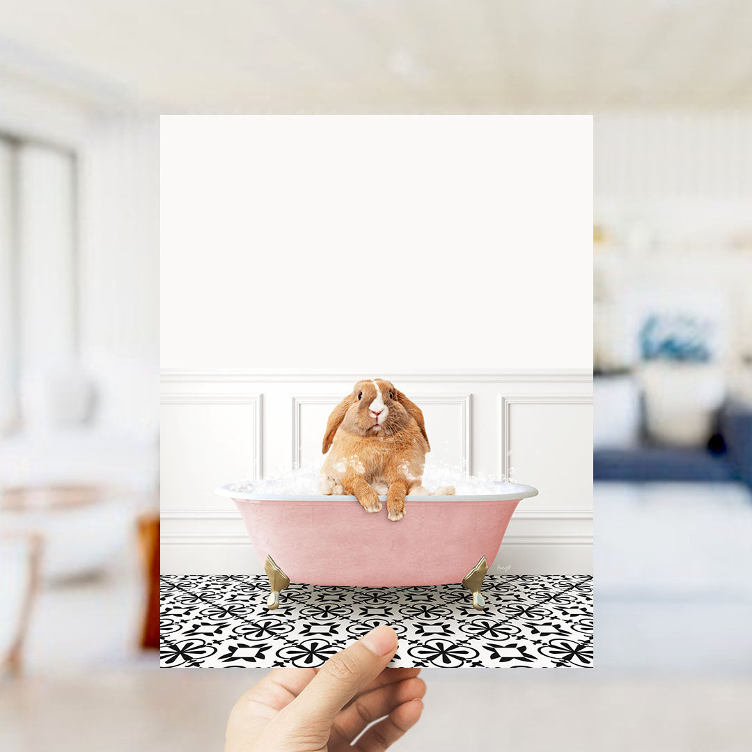 A brown rabbit sitting in a pink bathtub filled with bubbles, surrounded by a black and white patterned floor.