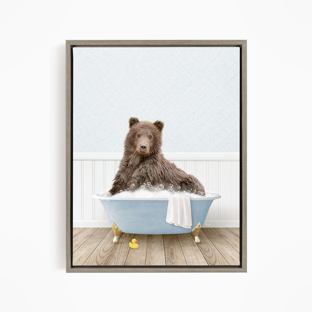 A brown bear sitting in a blue bathtub filled with bubbles, surrounded by rubber ducks.