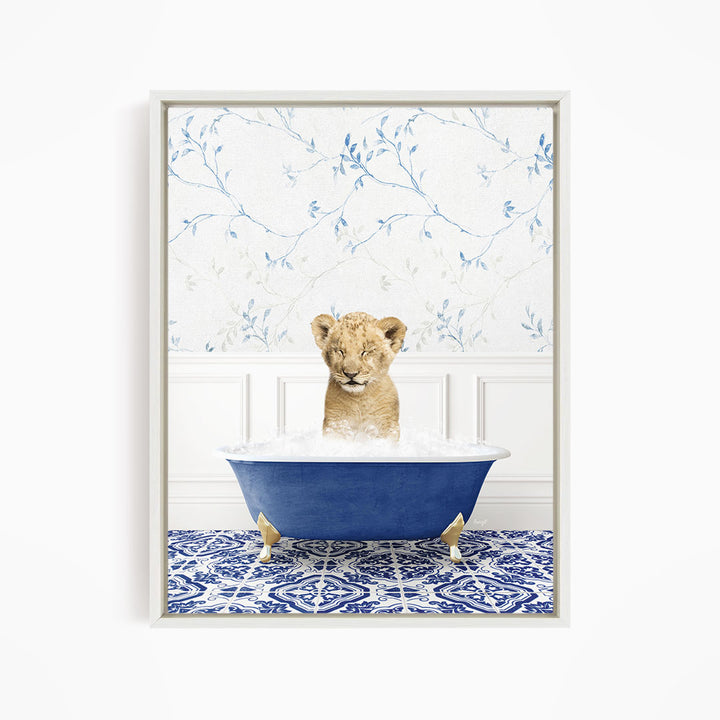 A young lion cub sitting in a blue bathtub filled with water, surrounded by a blue and white patterned floor.