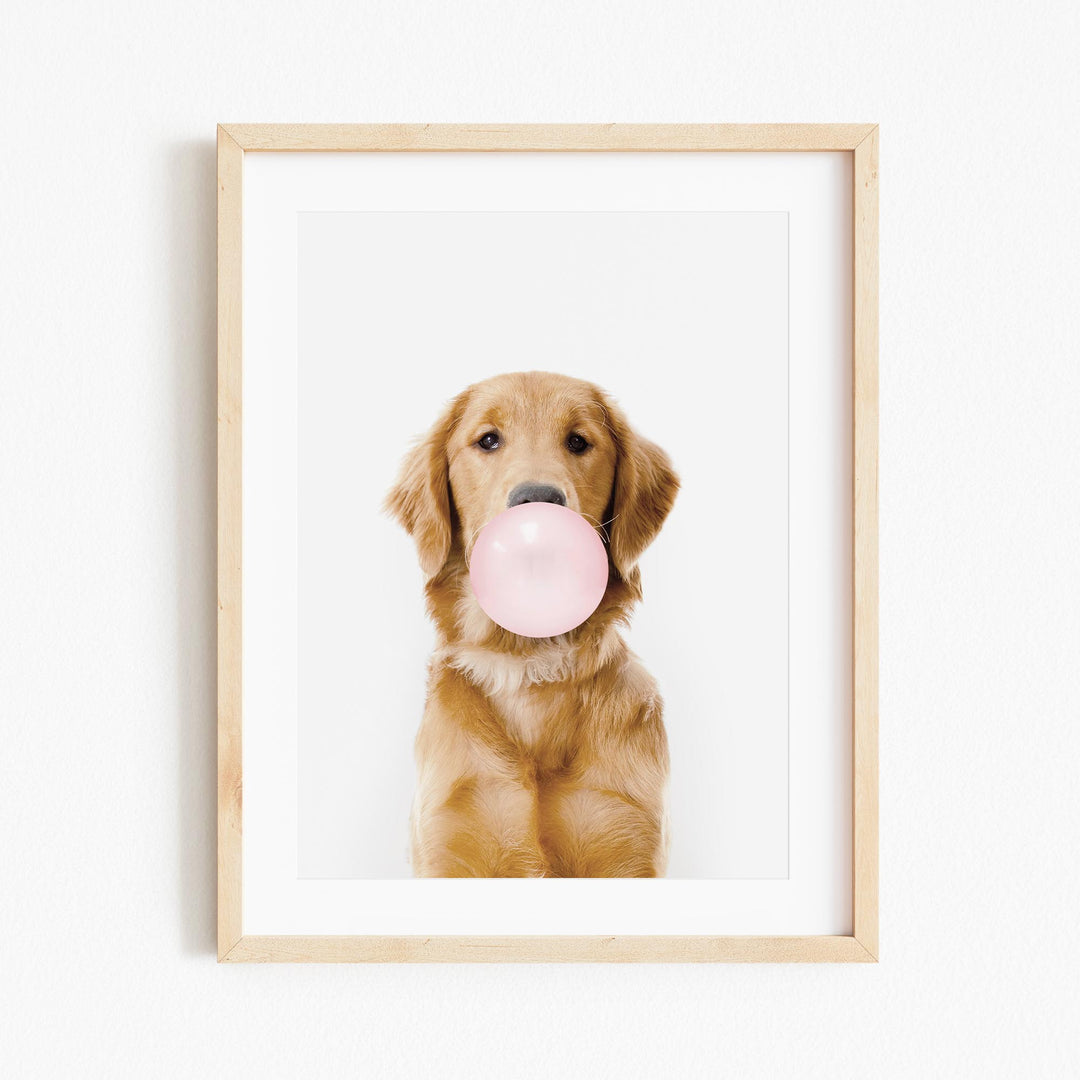 a picture of a dog with a pink bubble in its mouth