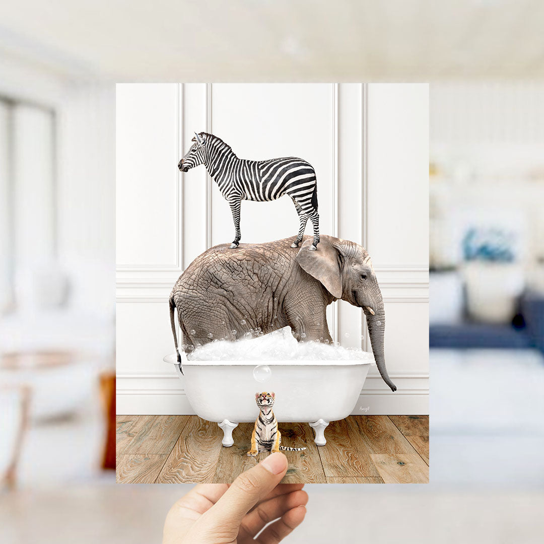 A hand holds up a collage of two images: a zebra standing on an elephant's back in a bathtub, and a small tiger standing in the tub with the zebra.