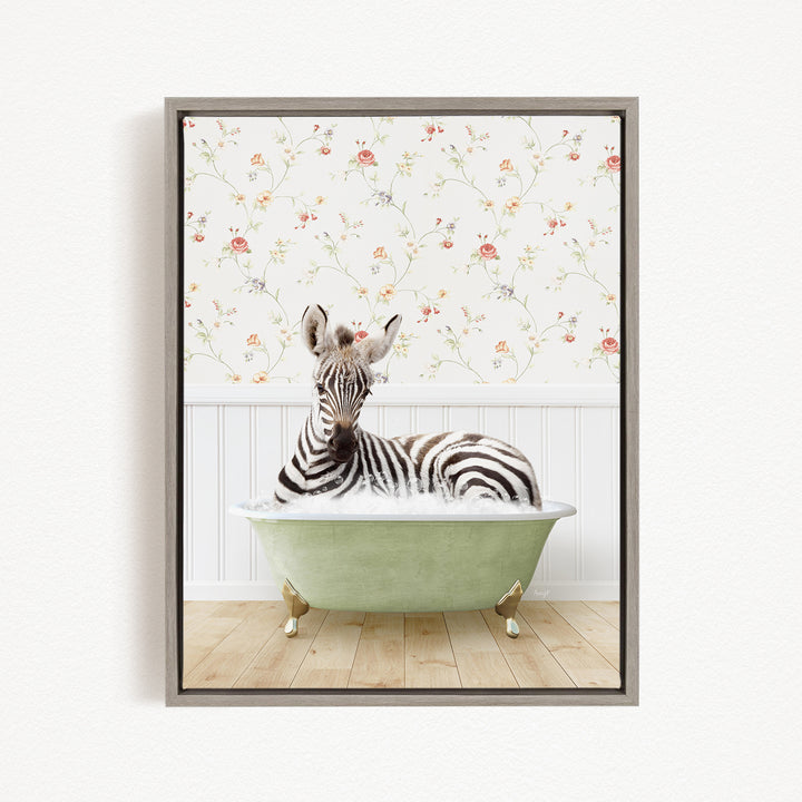 A zebra is sitting in a green bathtub, surrounded by a floral wallpaper.