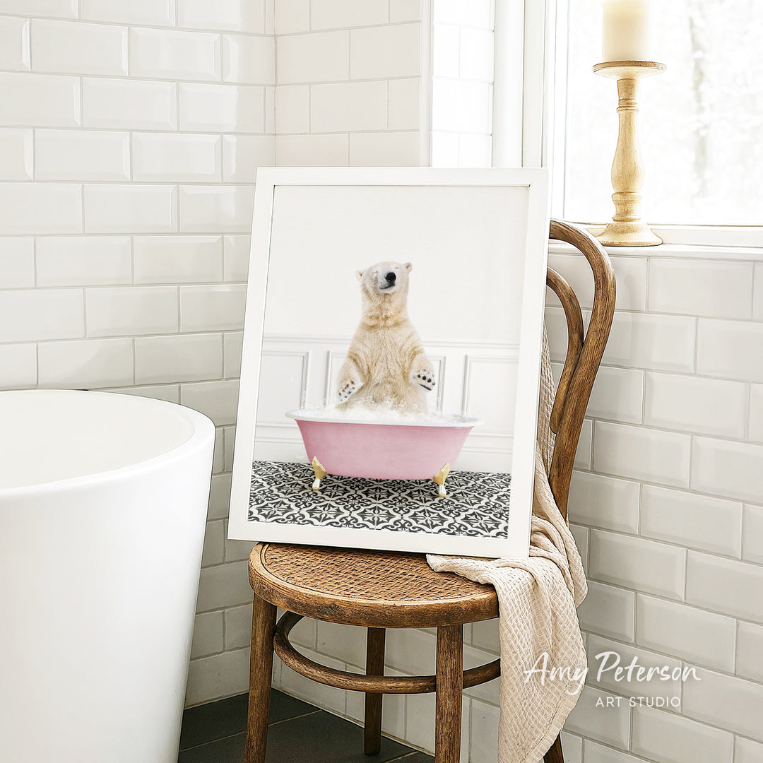A polar bear sitting in a pink bathtub in a bathroom, as depicted in a framed image.