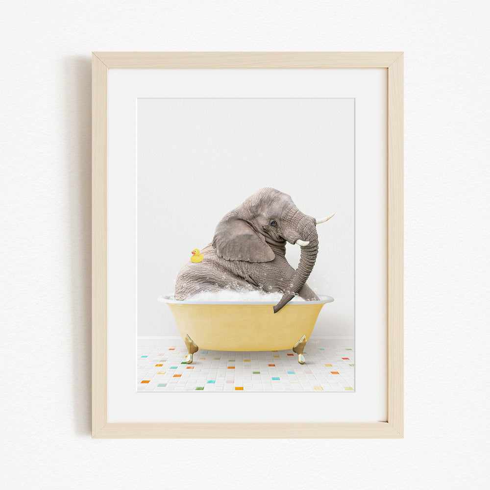A gray elephant is sitting in a yellow bathtub filled with bubbles, surrounded by a colorful tiled floor.